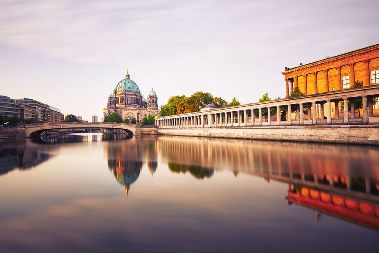 Berlin cathedral by river against sky