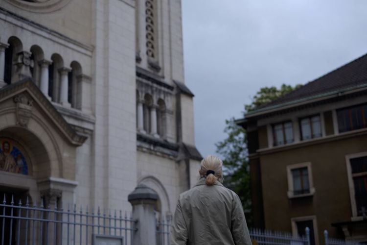 Rear view of man statue against building