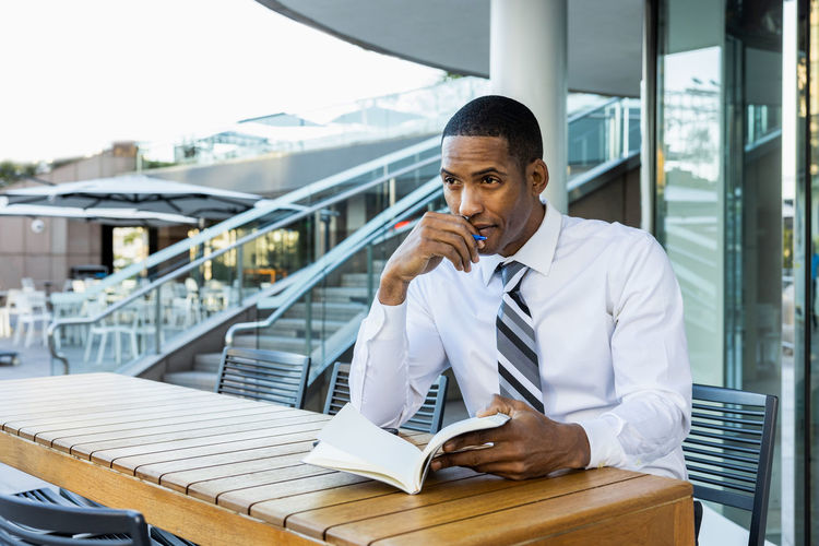 Young man using mobile phone in office