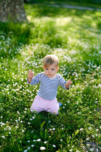 Cute baby girl on field