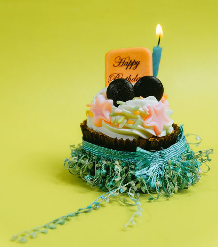 Close-up of cake on table against yellow background
