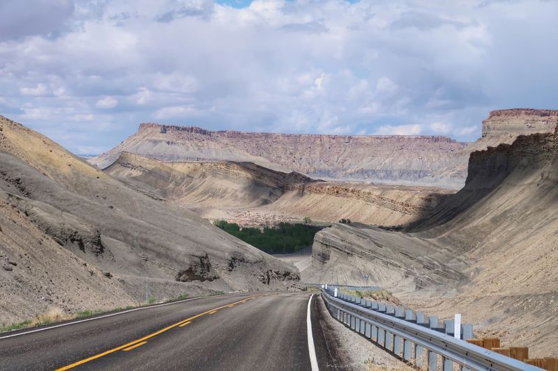 Strange landscape of a road through barren grey hills and valleys in utah