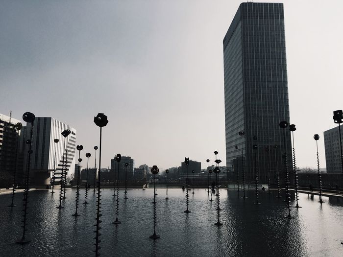 Pond against buildings in city