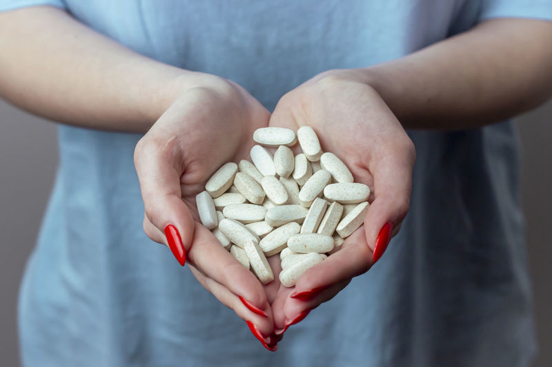 Many pills in the female hands of a doctor. medical background. drug overdose. poisoning. 