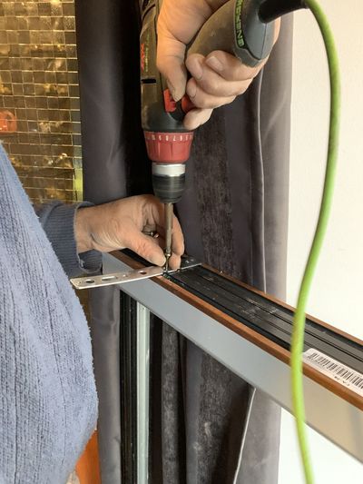 Working hands with an electric screwdriver 