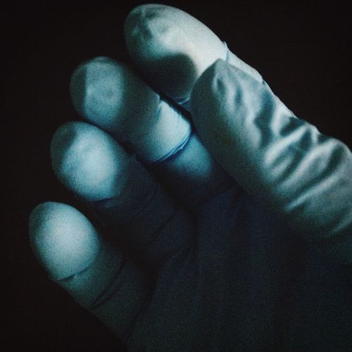 Close-up of hand over black background