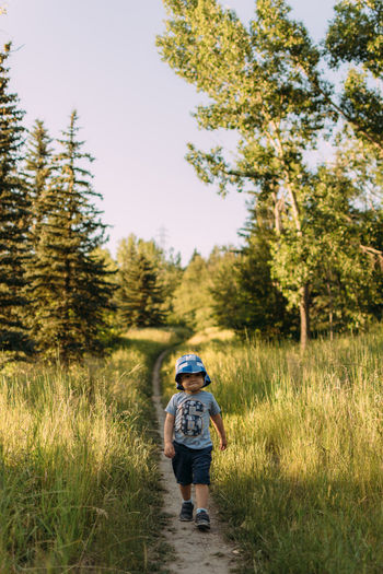 View of boy walking on field