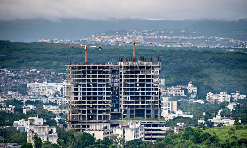 Twin, tall buildings under construction in  maharashtra, india. new infrastructure under development