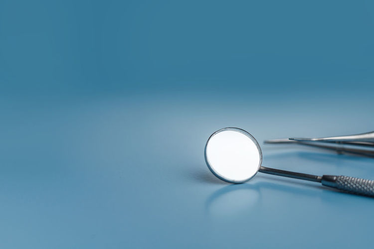 Close-up of stethoscope against blue background