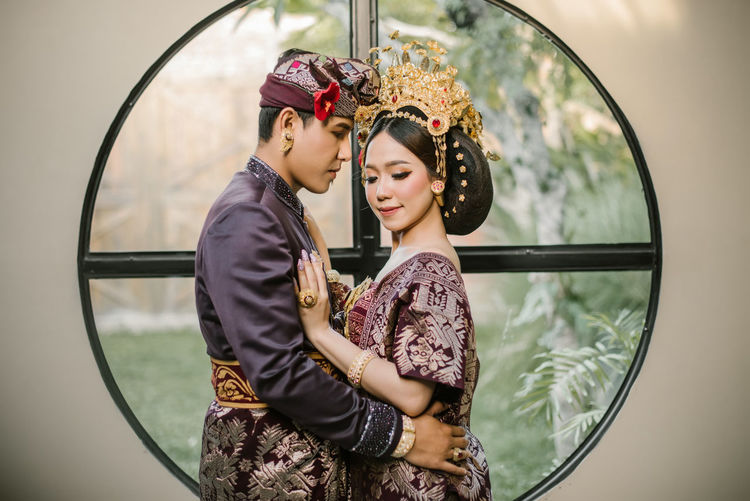 Young couple standing on mirror