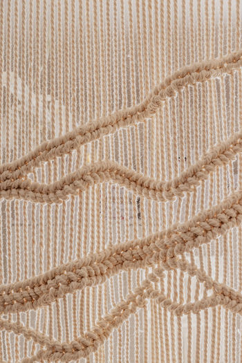 Homemade white macrame texture. home scandinavian boho decoration background