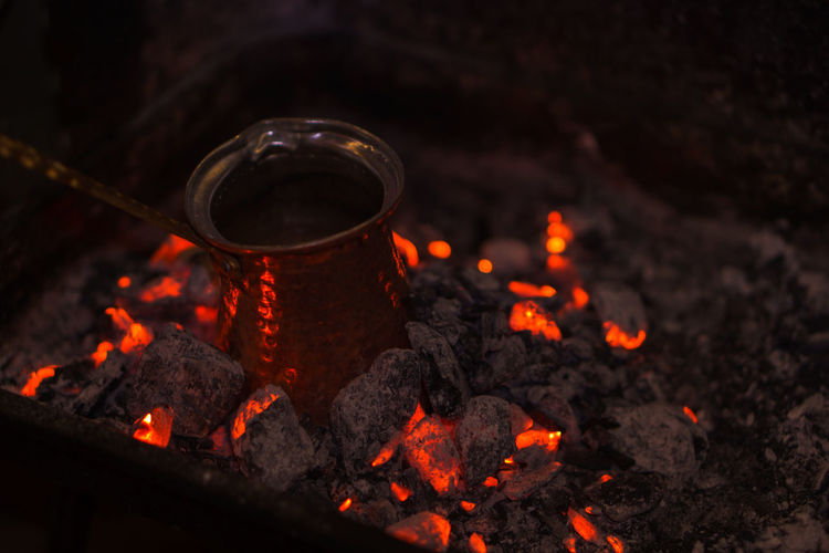 Antique copper sauce pan on burning coal