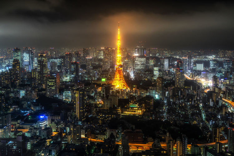 High angle view of illuminated cityscape against sky at night