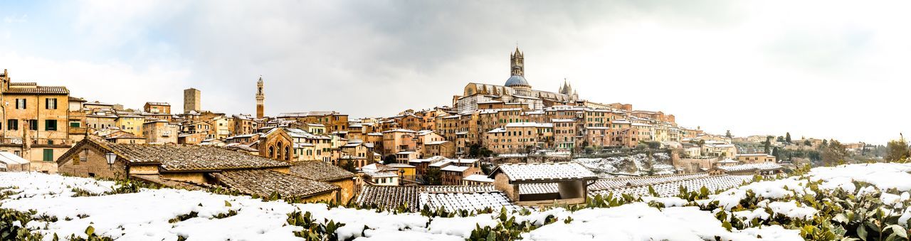 Panoramic view of sienna city against sky during snowy winter