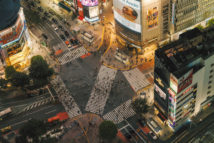 High angle view of illuminated street cross amidst buildings in city