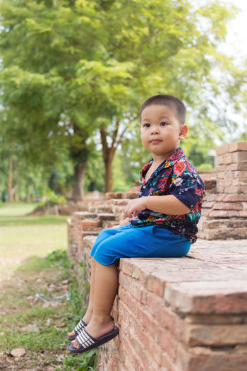 Portrait of boy sitting outdoors