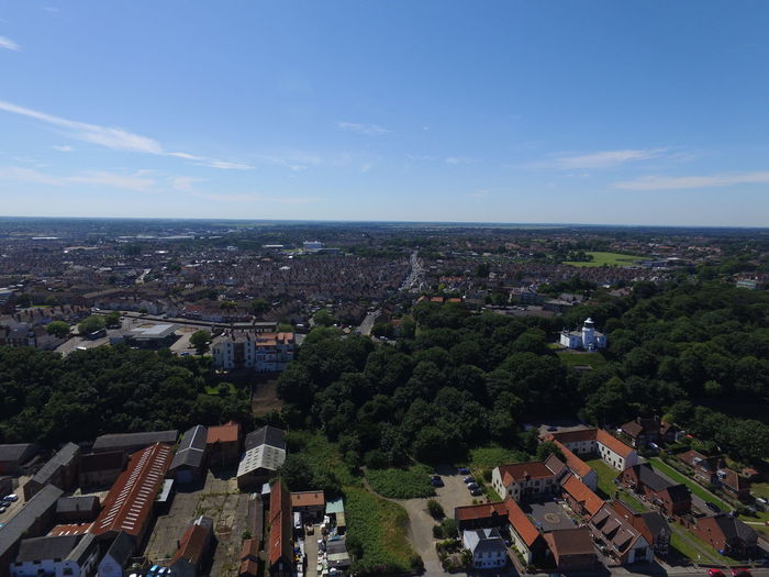 Aerial view of landscape against blue sky
