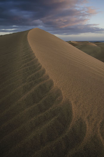 Sand dune ripples against the sky