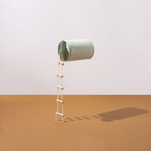 Pastel blue can with attached ladders. minimalist concept. square layout