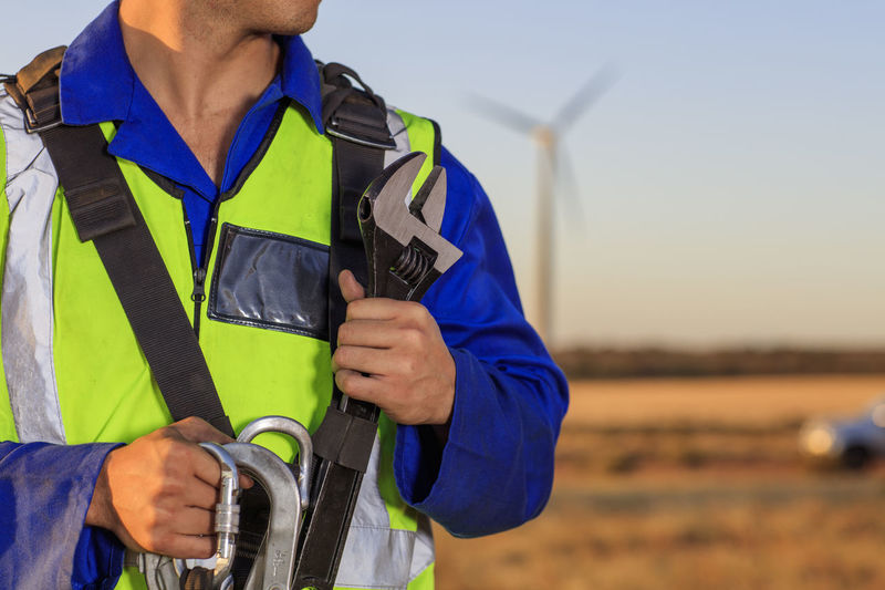 Close-up of technician with equipment on a wind farm