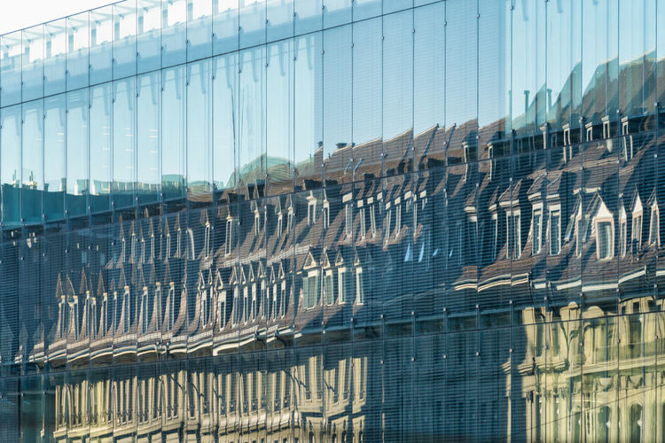 Digital composite image of glass building against sky