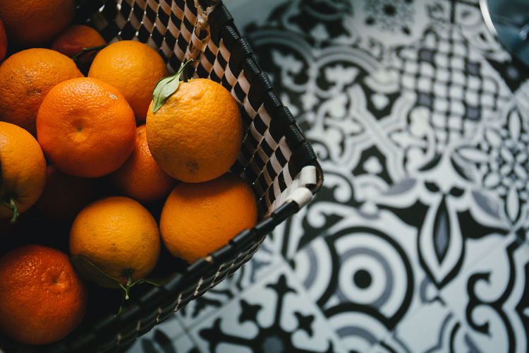 High angle view of oranges in basket on table
