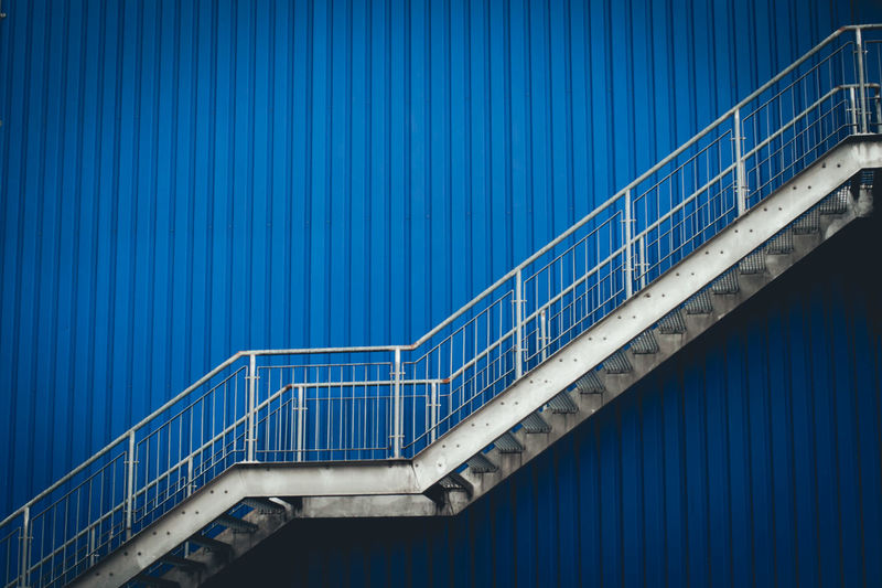 Low angle view of staircase against blue wall