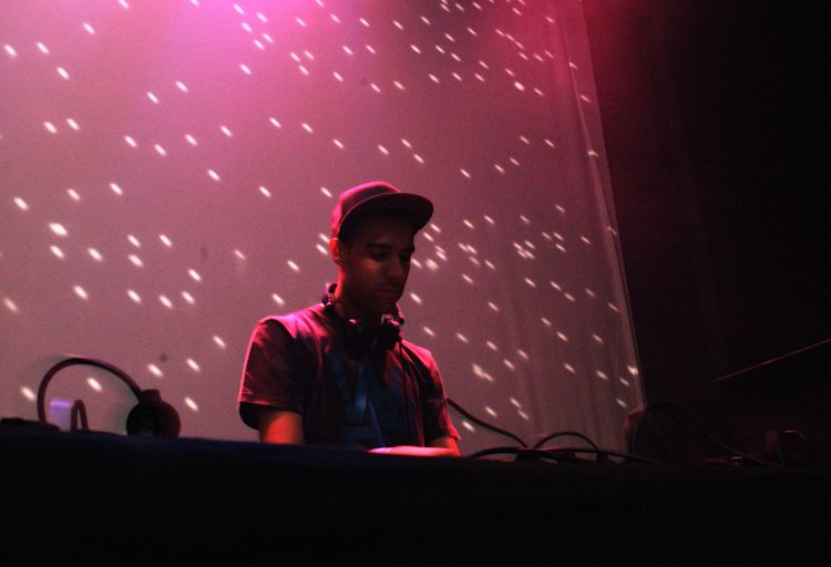 Man wearing headphones in illuminated nightclub