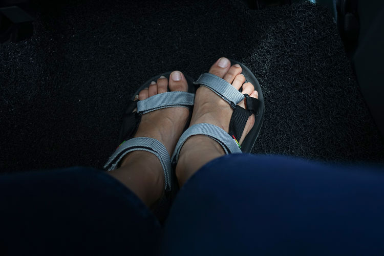 Low section of woman wearing sandal