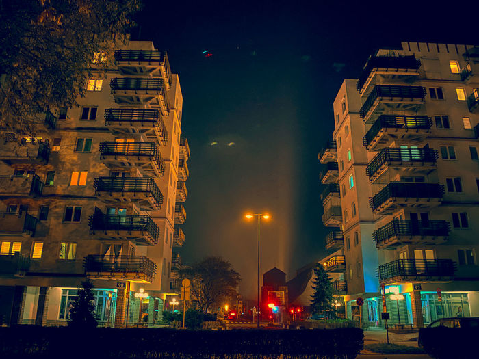 Illuminated buildings against sky at night
