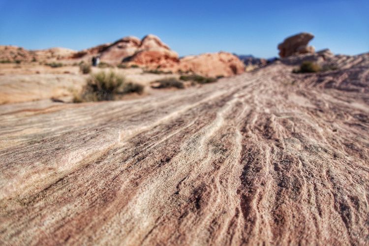 Surface level of desert against sky
