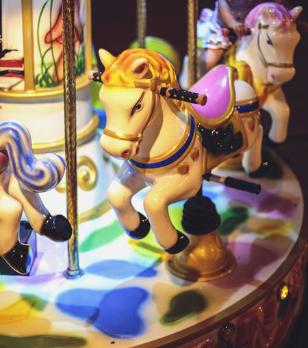 Close-up of carousel horses at night
