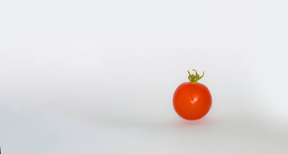 Close-up of cherry tomatoes against white background
