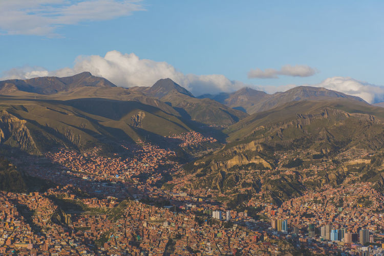 Scenic view of city with mountains in background