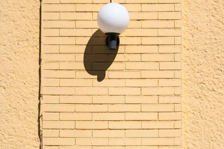 Low angle view of wall lamp with shadow
