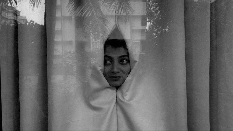 Portrait of woman wrapped in curtain