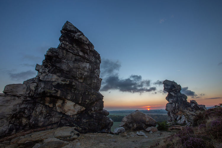 Rock formations against sky during sunset