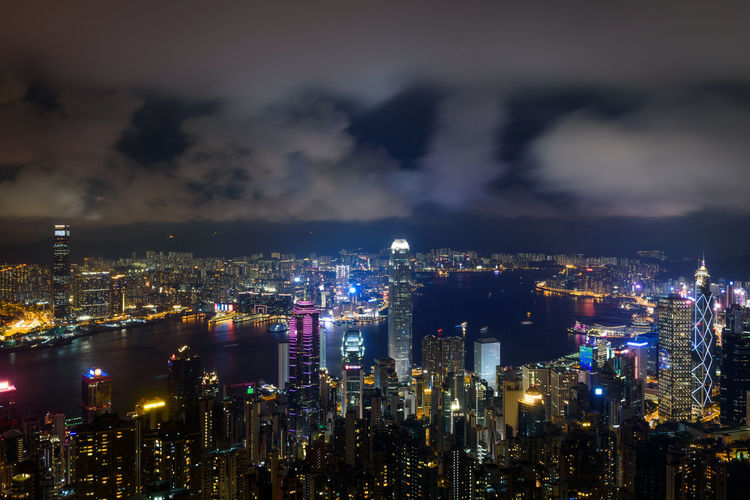 Illuminated cityscape against sky at night