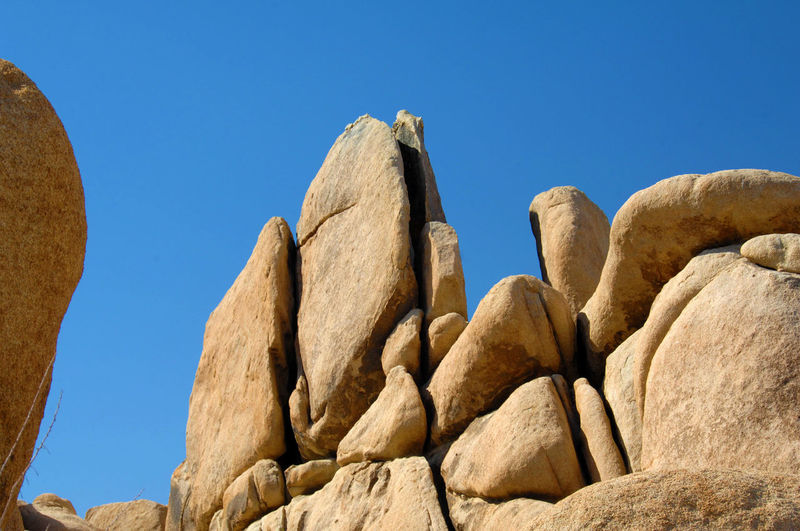 Low angle view of rock formations against clear blue sky at joshua tree national park