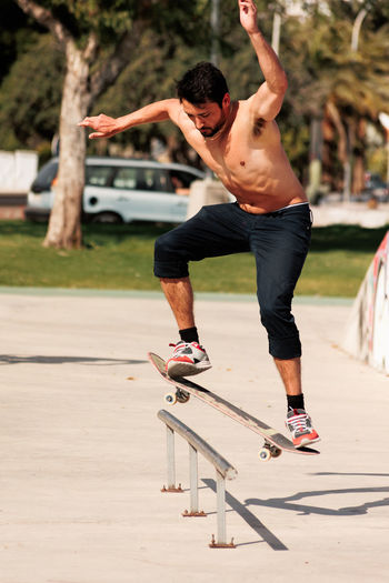 Full length of man skateboarding on road