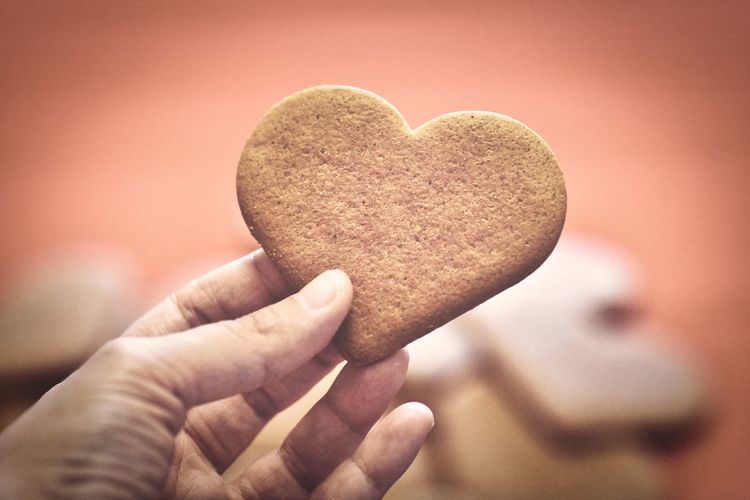 Close-up of hand holding heart shape cookies