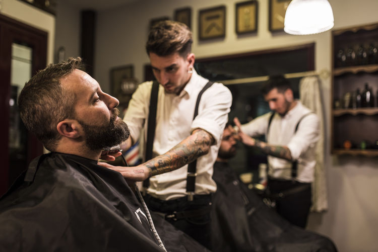 men in barber shop working and haircuts 30-35 Years Old Employee Work Working Adult Barber Barber Shop Beard Beauty Spa Body Care Business Finance And Industry Customer Customer Day Hair Salon Hairdresser Hairstyle Handsome Indoors Job Lifestyles Male Beauty Men Night Occupation People person Real People Service Sitting Skill Small Business Two People Working Young Adult Small Business Heroes