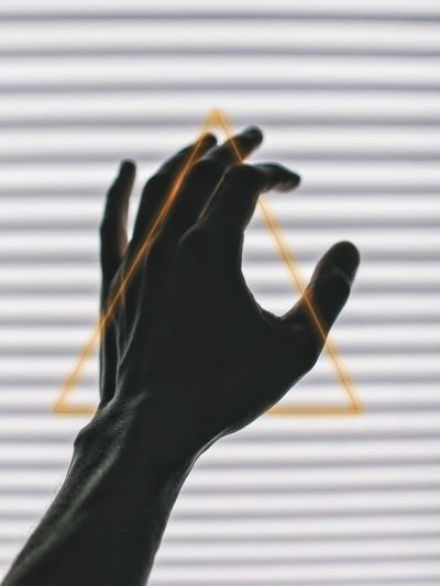 Close-up of hand holding black background