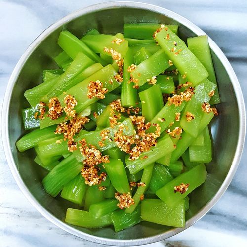 Directly above shot of green vegetable with sesame seed in bowl
