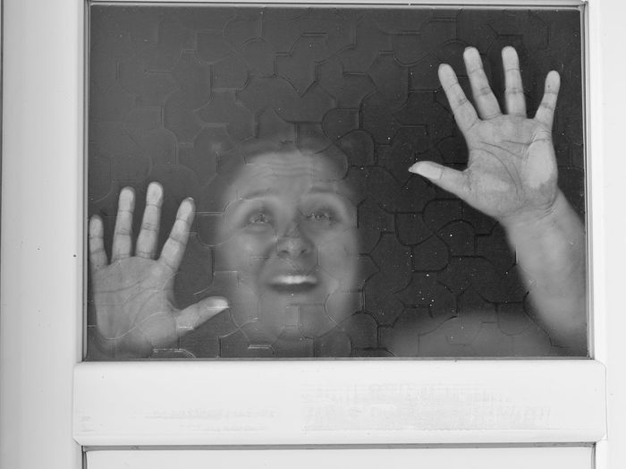 Woman screaming behind window