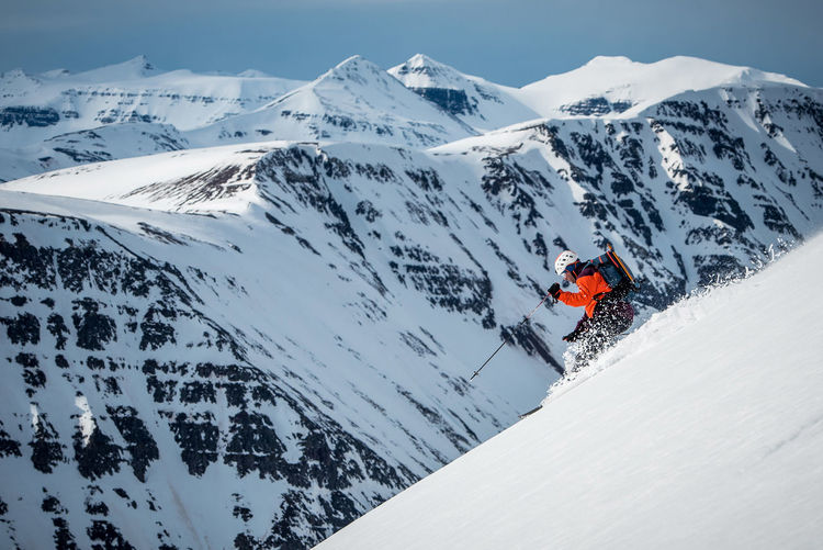A man skiing on a mountain in iceland during the day