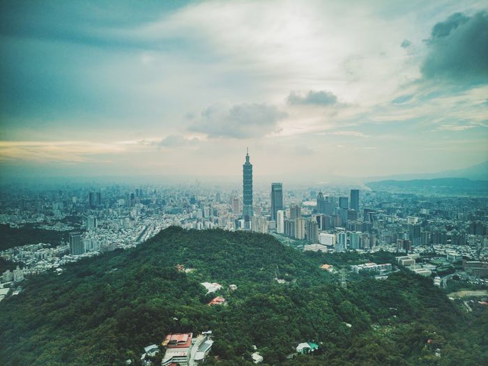 Taipei 101 amidst cityscape against sky