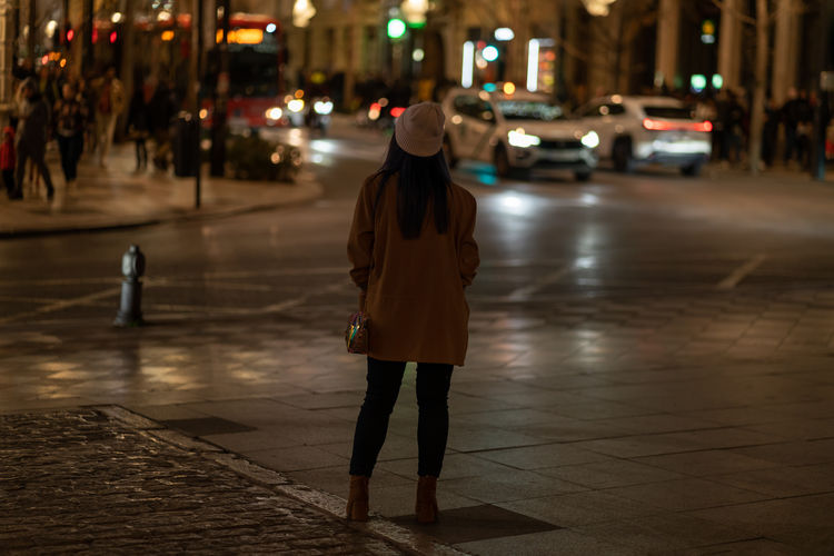 Rear view of woman walking on street