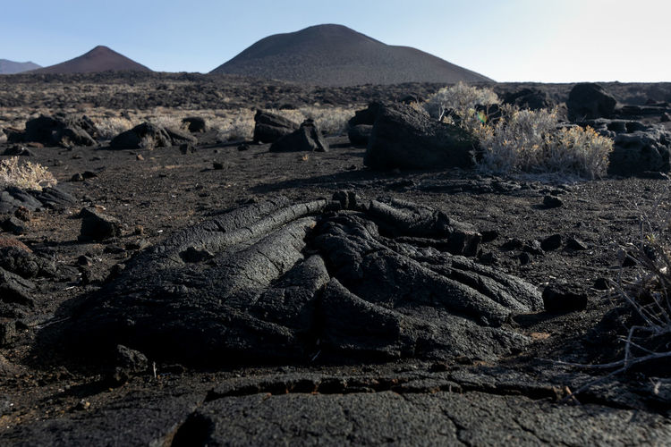 Scenic view of rocks on land against sky
