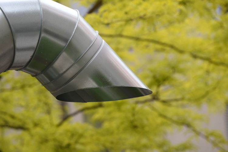 Low angle view of umbrella against trees